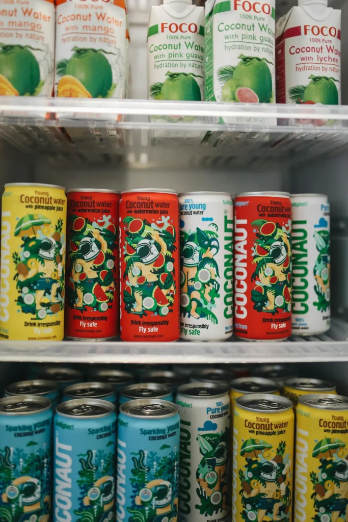 Beverage cans with colorful packaging labels displaying product information and brand identity